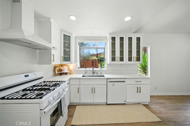 24322 Via Las Junitas, Murrieta, CA 92562 - kitchen featuring white appliances, wall chimney exhaust hood, white cabinets, wood finished floors, and recessed lighting