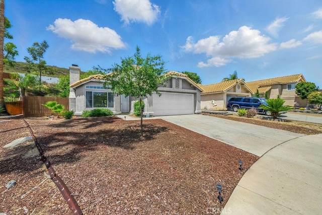 24322 Via Las Junitas, Murrieta, CA 92562 - view of front facade featuring a garage, concrete driveway, a chimney, stucco siding, and a tile roof