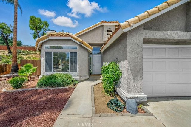 24322 Via Las Junitas, Murrieta, CA 92562 - view of front of property with stucco siding, a tile roof, and an attached garage