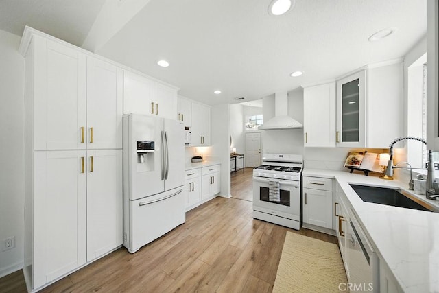 24322 Via Las Junitas, Murrieta, CA 92562 - kitchen with white appliances, wall chimney range hood, white cabinetry, light wood-style flooring, and recessed lighting