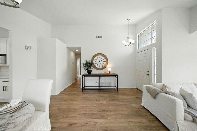 24322 Via Las Junitas, Murrieta, CA 92562 - entryway with a towering ceiling, a chandelier, and wood finished floors