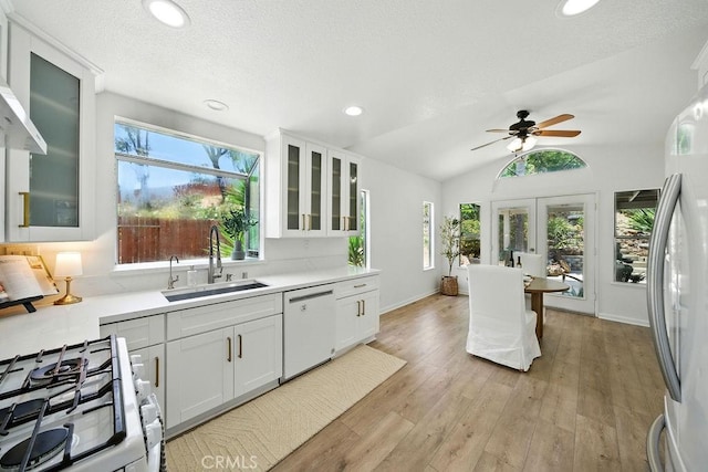 24322 Via Las Junitas, Murrieta, CA 92562 - kitchen with white appliances, light countertops, white cabinets, ceiling fan, and light wood-style floors