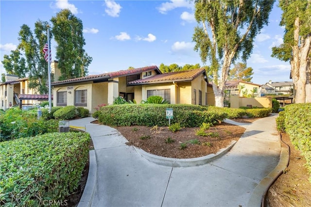 25521 Indian Hill Ln Unit L, Laguna Hills, CA 92653 - mediterranean / spanish home featuring a tile roof and stucco siding