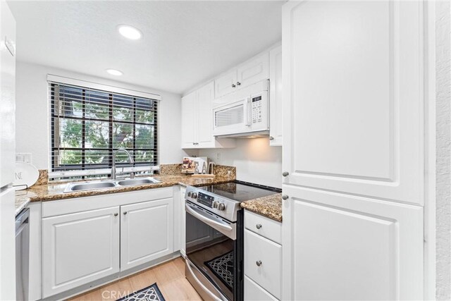 25521 Indian Hill Ln Unit L, Laguna Hills, CA 92653 - kitchen featuring stainless steel appliances, light wood-style floors, white cabinets, stone counters, and recessed lighting