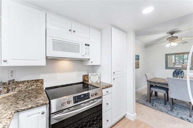 25521 Indian Hill Ln Unit L, Laguna Hills, CA 92653 - kitchen featuring electric stove, white microwave, white cabinets, stone counters, and recessed lighting