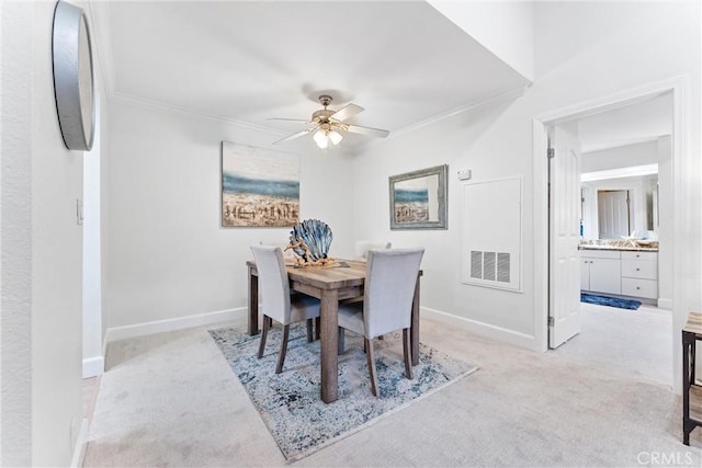 25521 Indian Hill Ln Unit L, Laguna Hills, CA 92653 - dining area featuring light colored carpet, ceiling fan, and crown molding