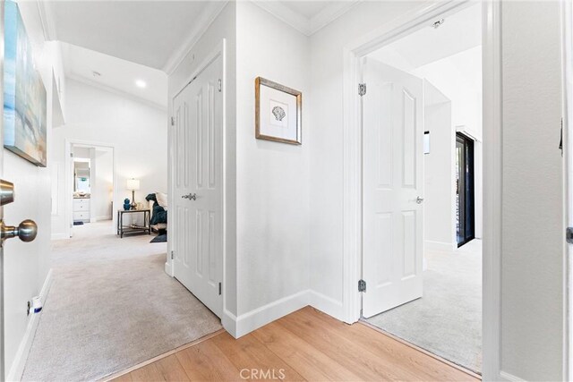 25521 Indian Hill Ln Unit L, Laguna Hills, CA 92653 - hall with light wood-style floors, crown molding, recessed lighting, vaulted ceiling, and light carpet