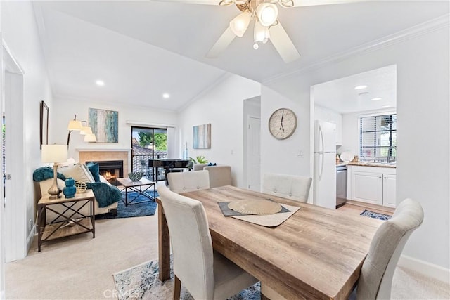 25521 Indian Hill Ln Unit L, Laguna Hills, CA 92653 - dining area with light colored carpet, a ceiling fan, ornamental molding, a fireplace, and lofted ceiling