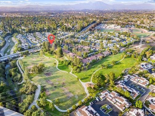 25521 Indian Hill Ln Unit L, Laguna Hills, CA 92653 - aerial view of property's location with nearby suburban area, a mountain backdrop, and a golf club