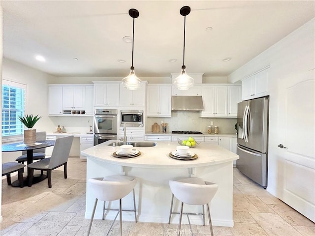 37 Roycroft, Irvine, CA 92620 - kitchen featuring stainless steel appliances, under cabinet range hood, stone tile floors, white cabinetry, and recessed lighting