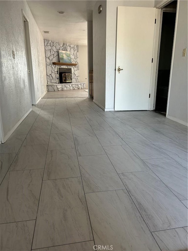 13915 Spring Valley Pkwy, Victorville, CA 92395 - hallway with baseboards and marble look tile flooring