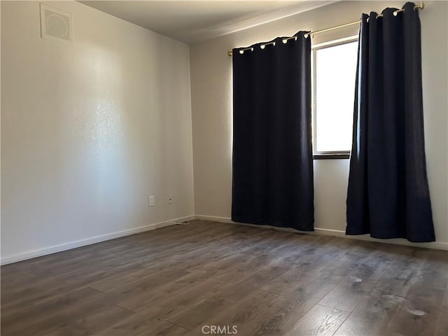 13915 Spring Valley Pkwy, Victorville, CA 92395 - unfurnished room with dark wood-style flooring and baseboards