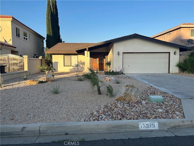 13915 Spring Valley Pkwy, Victorville, CA 92395 - ranch-style home with stucco siding, an attached garage, and concrete driveway