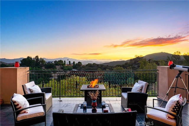 24410 Mulholland, Calabasas, CA 91302 - patio terrace at dusk featuring a mountain view and an outdoor living space with a fire pit