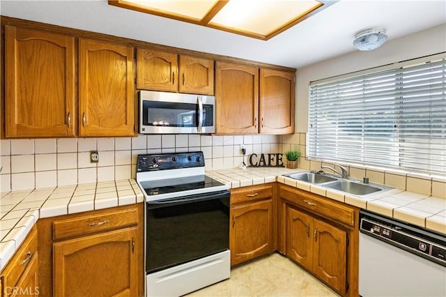 903 San Pablo Ave, Merced, CA 95348 - kitchen featuring white appliances, tile counters, and tasteful backsplash