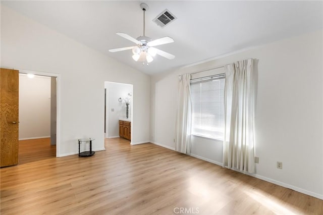 903 San Pablo Ave, Merced, CA 95348 - unfurnished bedroom featuring vaulted ceiling, light wood-style flooring, ceiling fan, and connected bathroom