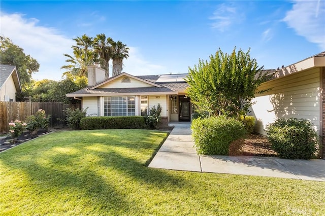 903 San Pablo Ave, Merced, CA 95348 - view of front of property featuring solar panels, a chimney, brick siding, and roof with shingles