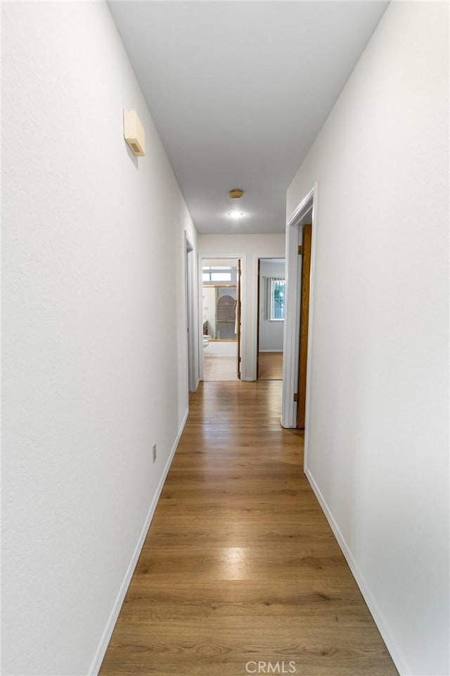 903 San Pablo Ave, Merced, CA 95348 - corridor featuring baseboards and light wood-style floors