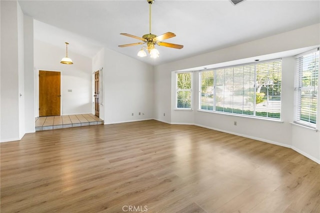 903 San Pablo Ave, Merced, CA 95348 - unfurnished living room featuring light wood finished floors, vaulted ceiling, and a ceiling fan