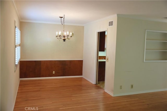 1230 N Mountain Ave, Claremont, CA 91711 - unfurnished room with wood finished floors, a chandelier, and crown molding