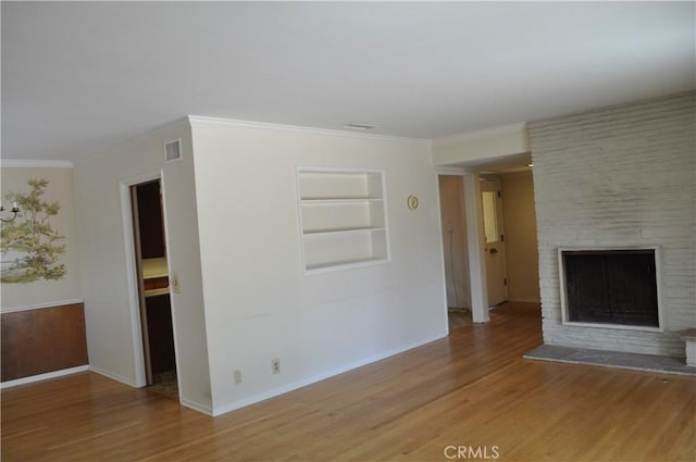 1230 N Mountain Ave, Claremont, CA 91711 - unfurnished living room featuring built in features, light wood-type flooring, a fireplace, and ornamental molding