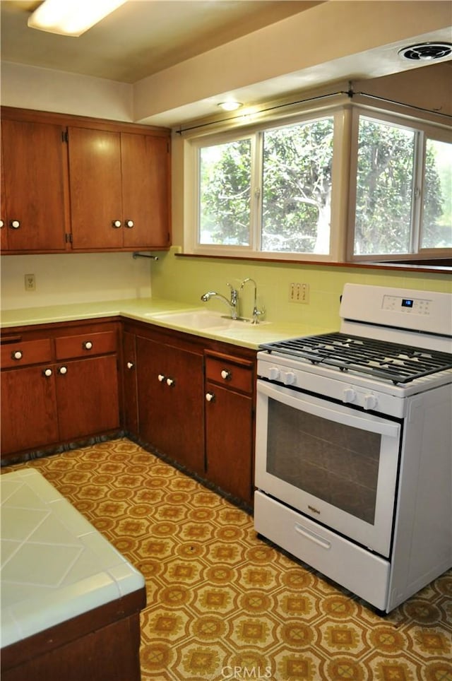 1230 N Mountain Ave, Claremont, CA 91711 - kitchen with white gas stove and light countertops