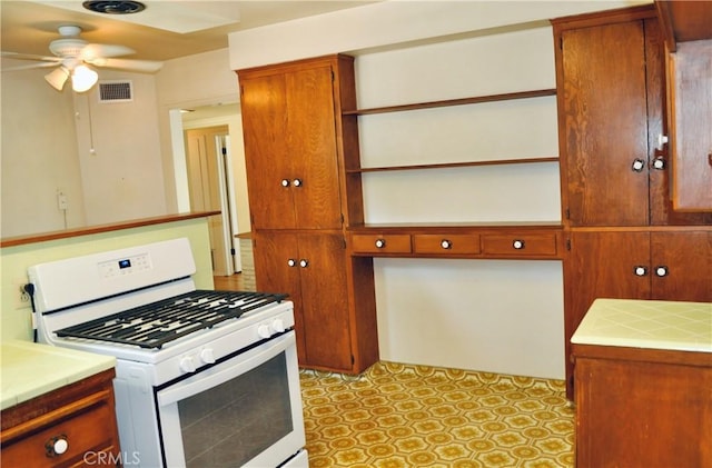 1230 N Mountain Ave, Claremont, CA 91711 - kitchen featuring white range with gas stovetop, tile countertops, open shelves, and ceiling fan