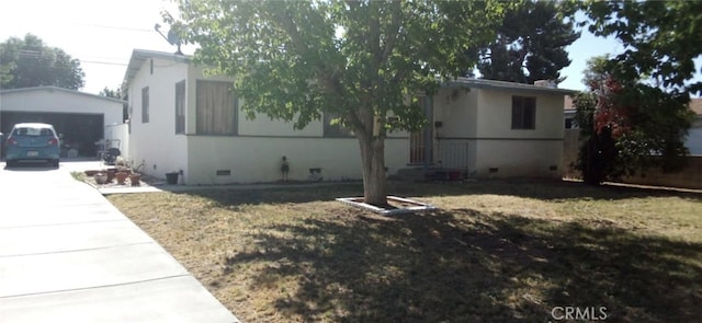 45417 11th St W, Lancaster, CA 93534 - view of side of home featuring a garage, an outdoor structure, and crawl space