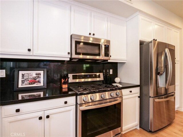 5429 Strand Unit 101, Hawthorne, CA 90250 - kitchen featuring stainless steel appliances, white cabinetry, and light wood-style floors