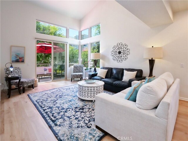 5429 Strand Unit 101, Hawthorne, CA 90250 - living room with light wood-type flooring and a high ceiling
