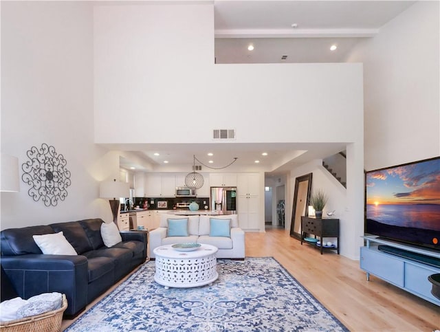 5429 Strand Unit 101, Hawthorne, CA 90250 - living area with light wood-style floors, beam ceiling, a towering ceiling, and recessed lighting