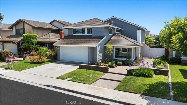 20 Whistling Isle, Irvine, CA 92614 - traditional-style home with a garage, driveway, a front lawn, and a tile roof