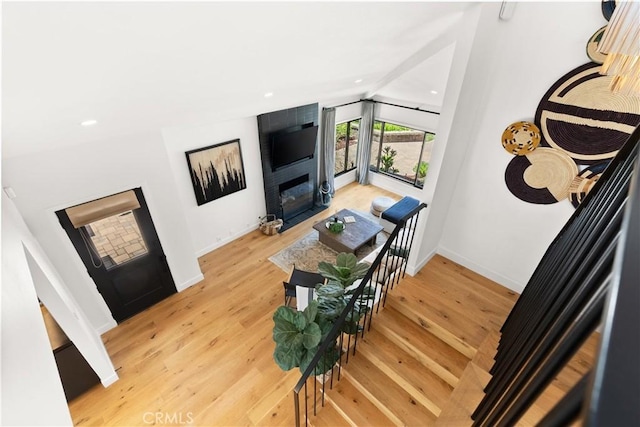 20 Whistling Isle, Irvine, CA 92614 - living room with a fireplace, light wood-style flooring, lofted ceiling, and recessed lighting