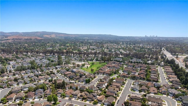 20 Whistling Isle, Irvine, CA 92614 - aerial overview of property's location with a mountainous background and nearby suburban area