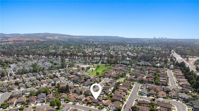 20 Whistling Isle, Irvine, CA 92614 - aerial overview of property's location featuring a mountainous background and nearby suburban area