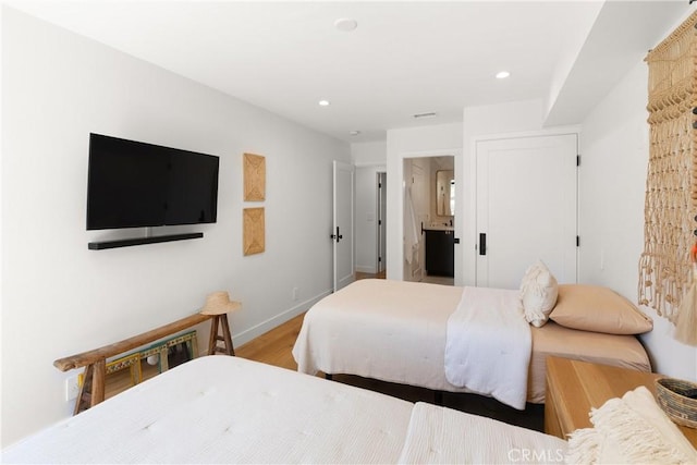 20 Whistling Isle, Irvine, CA 92614 - bedroom with wood finished floors, recessed lighting, and ensuite bathroom