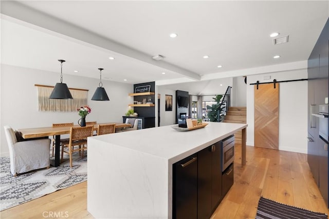 20 Whistling Isle, Irvine, CA 92614 - kitchen with a kitchen island, modern cabinets, light wood-style floors, recessed lighting, and light countertops