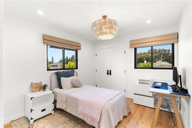20 Whistling Isle, Irvine, CA 92614 - bedroom with multiple windows, a chandelier, light wood finished floors, recessed lighting, and a closet