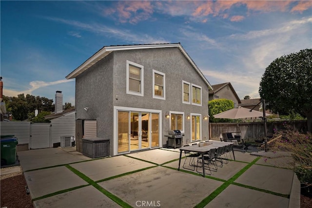 20 Whistling Isle, Irvine, CA 92614 - rear view of property featuring a gate, stucco siding, and a fenced backyard