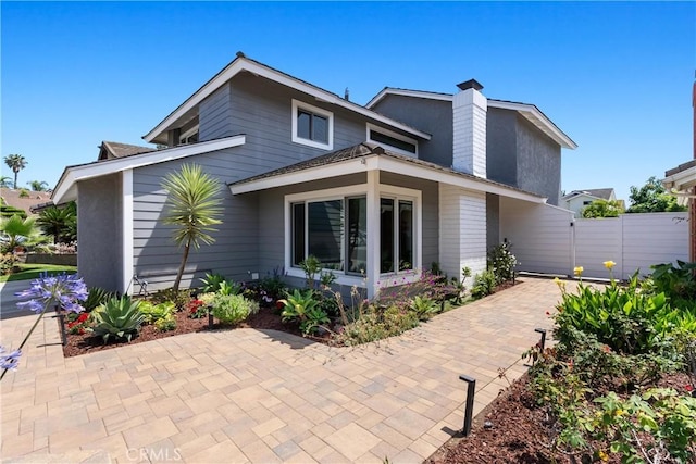 20 Whistling Isle, Irvine, CA 92614 - view of front of property with a patio area and a chimney