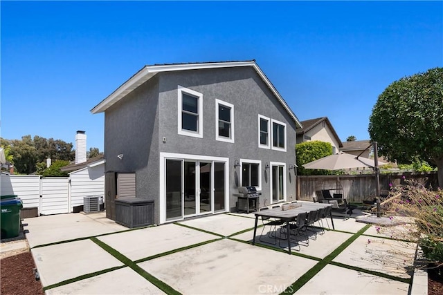 20 Whistling Isle, Irvine, CA 92614 - rear view of house with stucco siding, a fenced backyard, a patio area, and a gate
