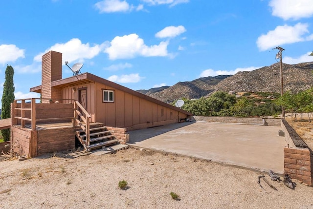 37882 Montezuma Valley Rd, Ranchita, CA 92066 - rear view of property featuring a mountain view, board and batten siding, a chimney, and a patio area