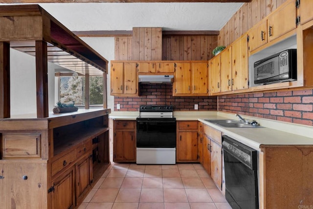 37882 Montezuma Valley Rd, Ranchita, CA 92066 - kitchen featuring black appliances, under cabinet range hood, light countertops, light tile patterned floors, and wooden walls