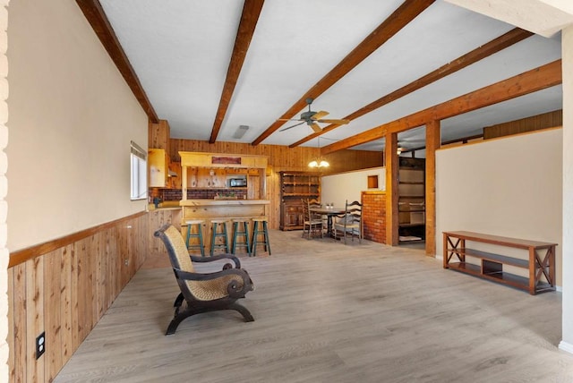 37882 Montezuma Valley Rd, Ranchita, CA 92066 - sitting room with wood walls, wood finished floors, a ceiling fan, beamed ceiling, and wainscoting