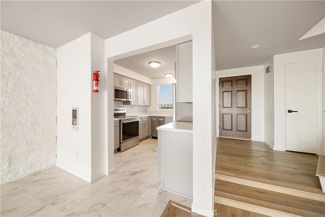 240 W Queen St Unit 10, Inglewood, CA 90301 - kitchen featuring appliances with stainless steel finishes, light countertops, and light marble finish flooring