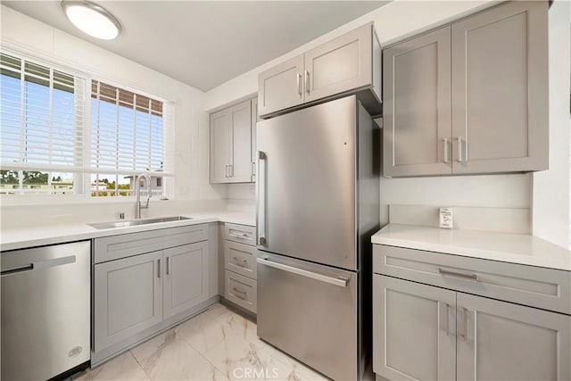 240 W Queen St Unit 10, Inglewood, CA 90301 - kitchen with appliances with stainless steel finishes, gray cabinets, light marble finish floors, and light countertops