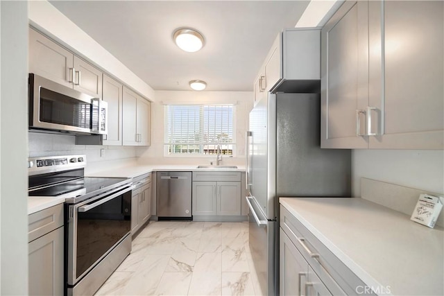 240 W Queen St Unit 10, Inglewood, CA 90301 - kitchen with appliances with stainless steel finishes, gray cabinetry, light marble finish flooring, and light countertops
