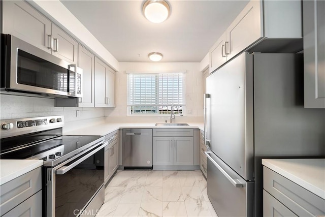 240 W Queen St Unit 10, Inglewood, CA 90301 - kitchen with stainless steel appliances, gray cabinets, light marble finish floors, and light countertops