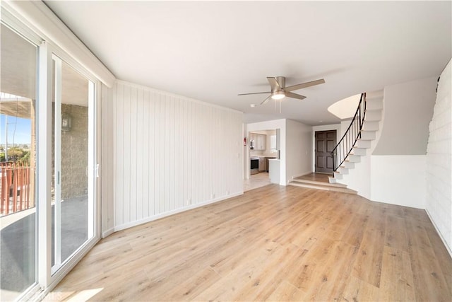 240 W Queen St Unit 10, Inglewood, CA 90301 - unfurnished living room featuring ceiling fan, light wood-style flooring, and stairway