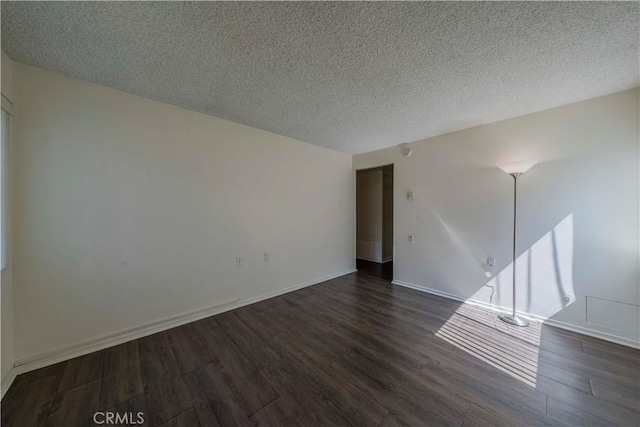 368 Avenida Castilla Unit B, Laguna Woods, CA 92637 - empty room featuring dark wood-style floors and a textured ceiling